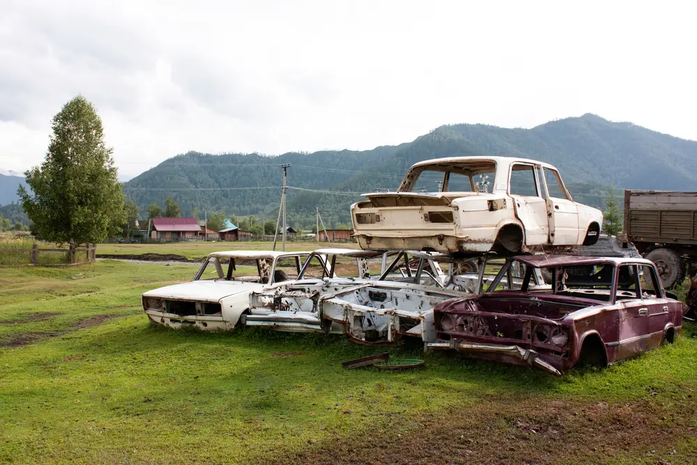 Car cemetery. Old rusty bodies of Russian cars in a mountain village