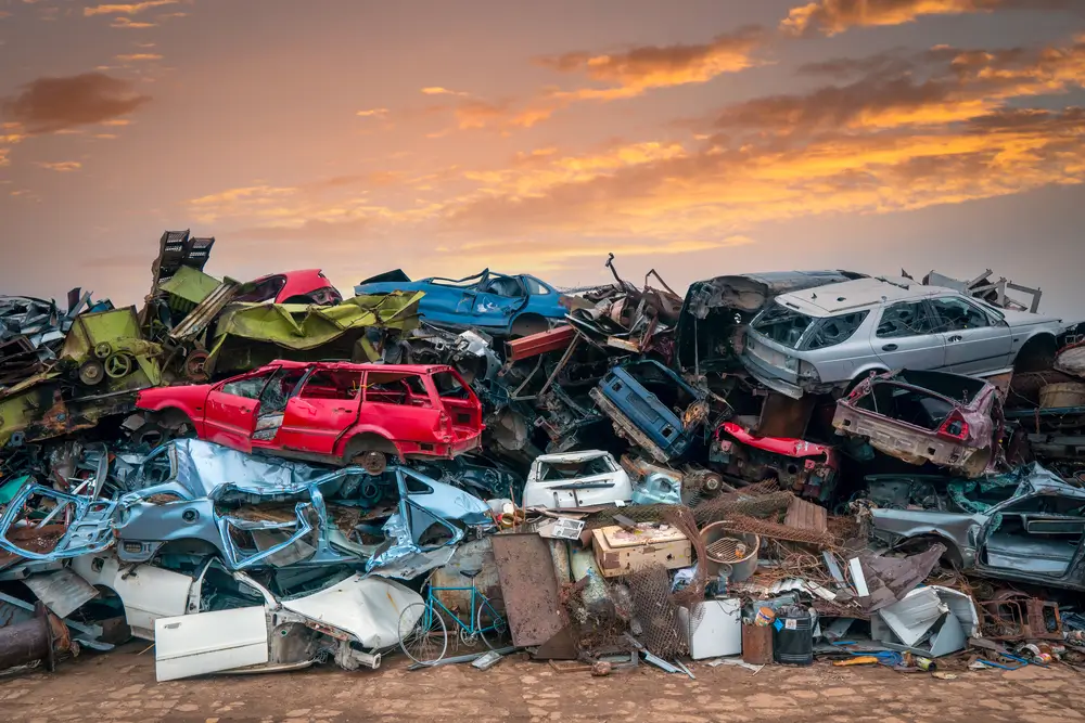 Damaged cars on the junkyard waiting for recycling or destruction