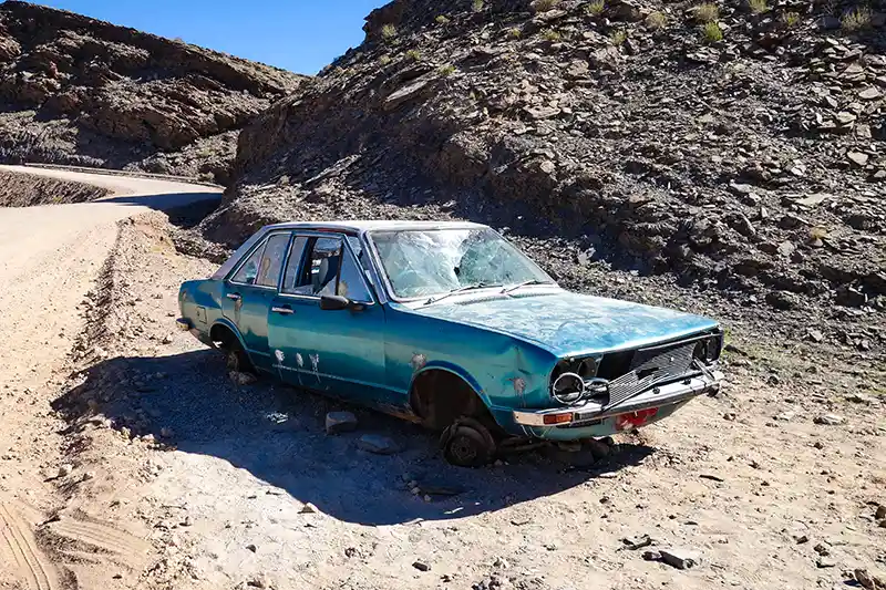 A Blue Car Wreck on Desert, Junk a Car Without a Title